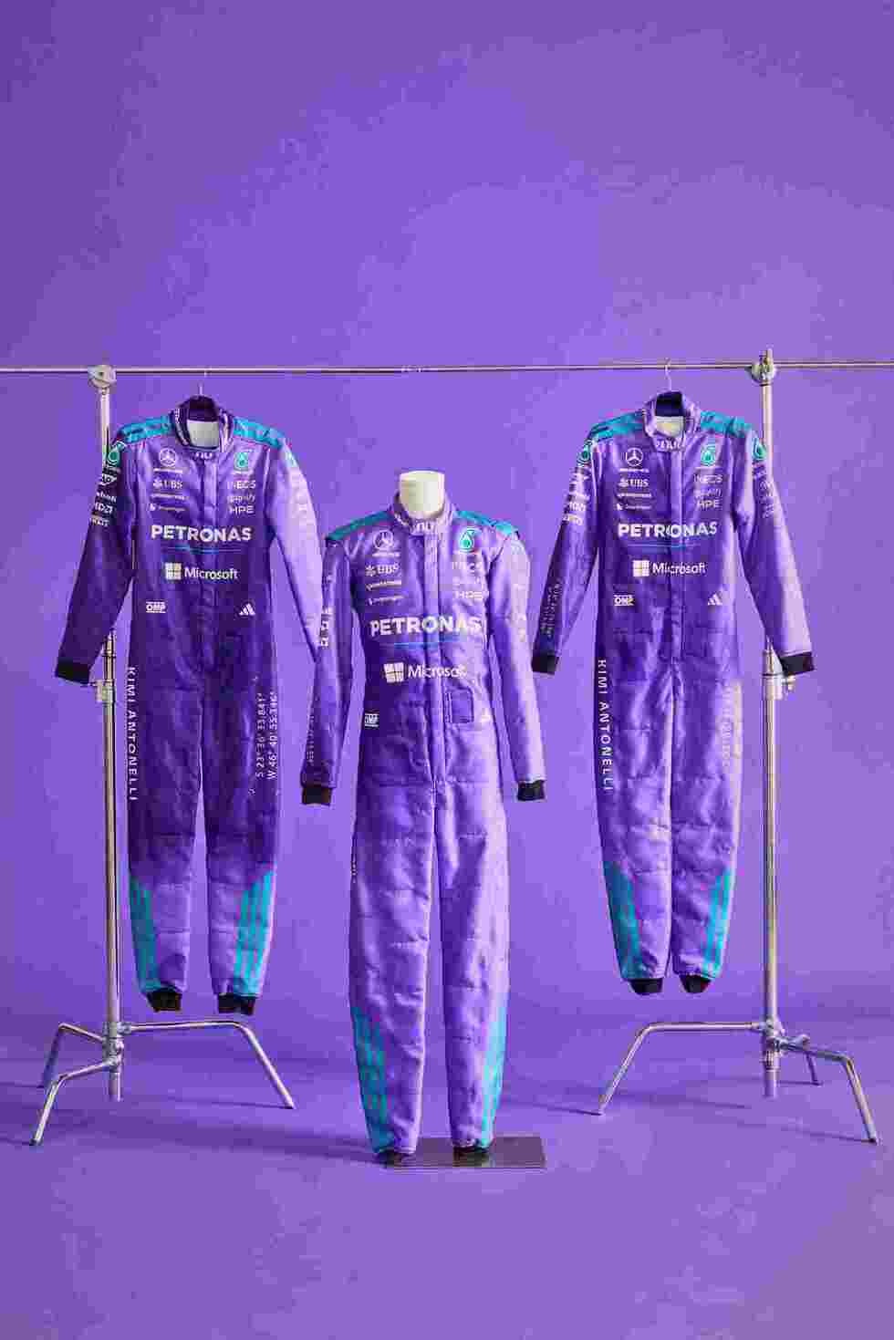Three Andrea Kimi Antonelli Mercedes 2026 Miami GP F1 racing suits on stands against a purple background with 'Petronas' branding - Kartx Gear