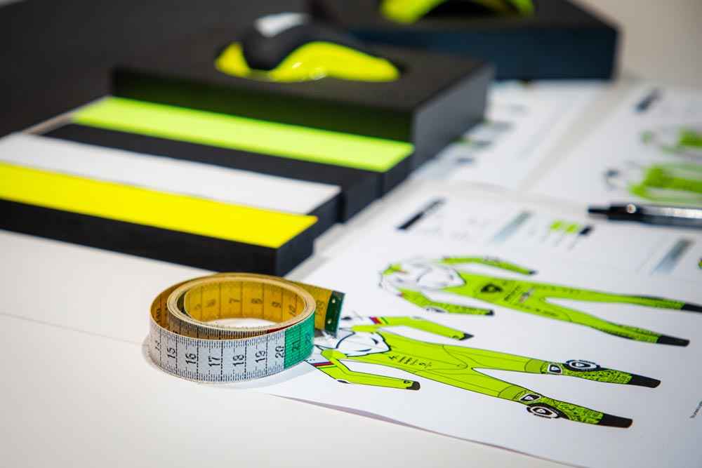 Measurement tools and clothing design prints on a table - Kartx Gear