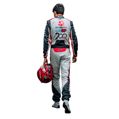 Esteban Ocon, wearing a 2025 Haas F1 200th Race Look Canadian GP racing suit, holding a helmet - Kartx Gear