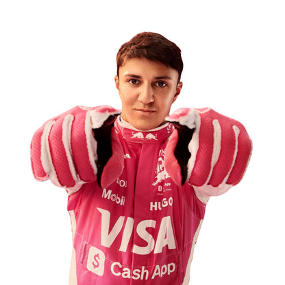 Isack Hadjar wearing a pink 2025 Miami GP VCARB F1 racing suit with various brand logos - Kartx Gear