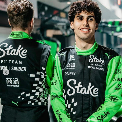 Two individuals, Gabriel Bortoleto and Nico Hulkenberg, wearing green and black 2025 Las Vegas GP Team Kick Sauber racing suits - Kartx Gear
