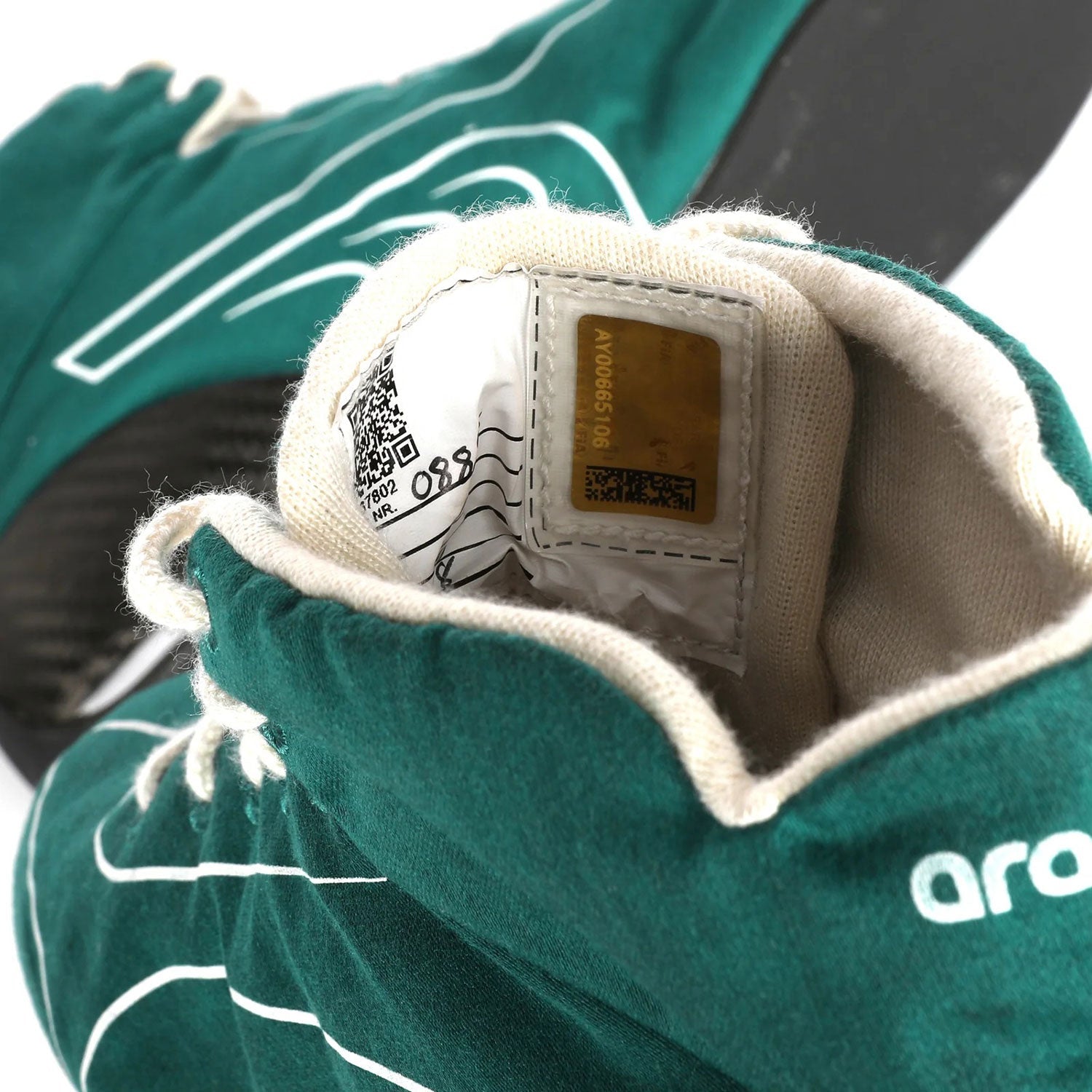 Close-up of a green Lance Stroll 2025 Aston Martin F1 Racing Shoes with a brand label - Kartx Gear