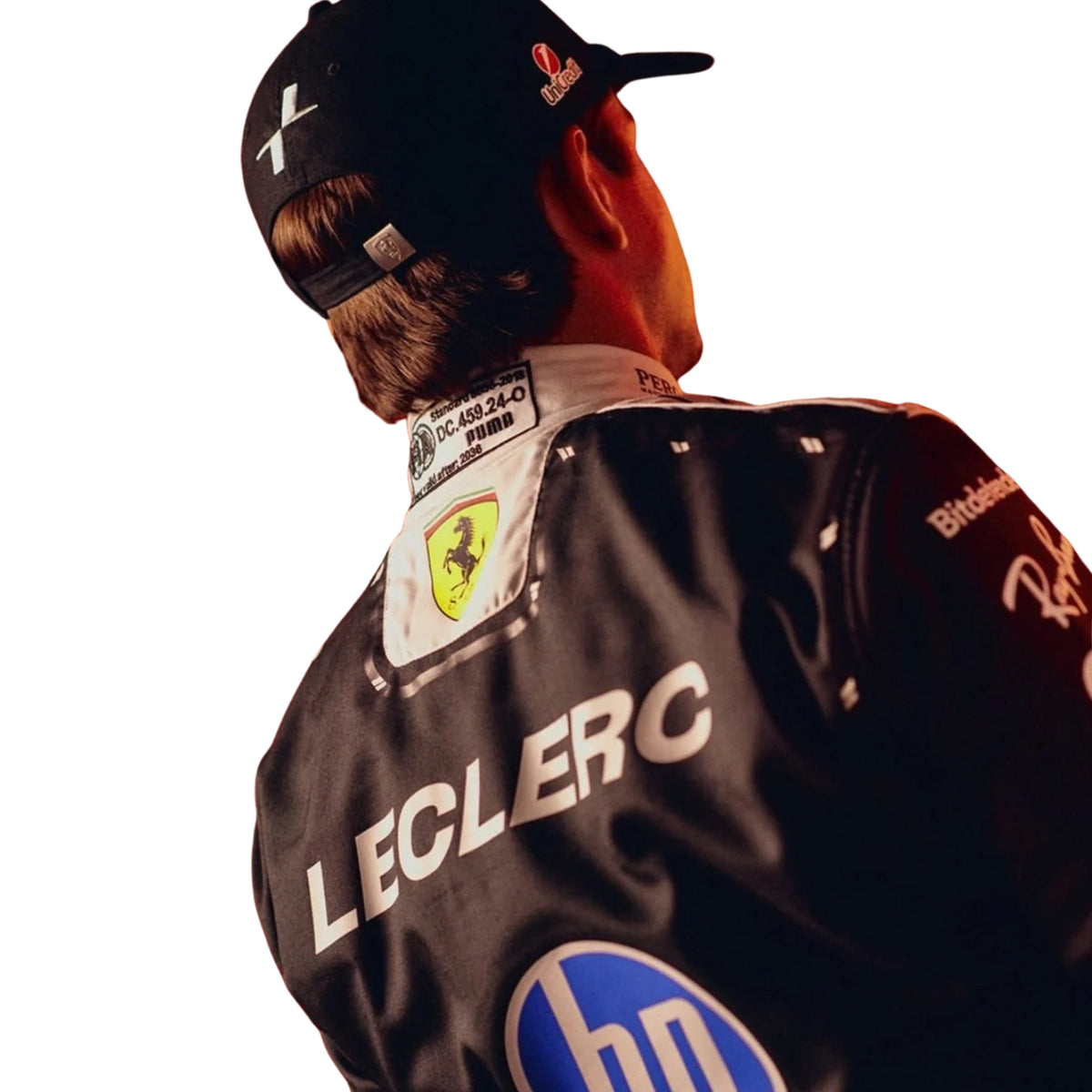 A Charles Leclerc wearing a Black Ferrari racing suit with sponsor logos, posed against a solid white background.