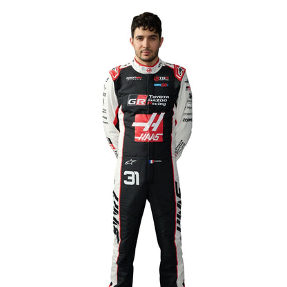 Esteban Ocon wearing a 2026 F1 Haas racing suit with various sponsor logos - Kartx Gear