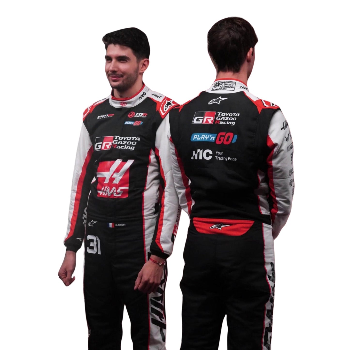 Esteban Ocon, wearing a Toyota Gazoo F1 Haas 2026 Racing racing suit with visible branding, standing with Oliver Bearman- Kartx Gear