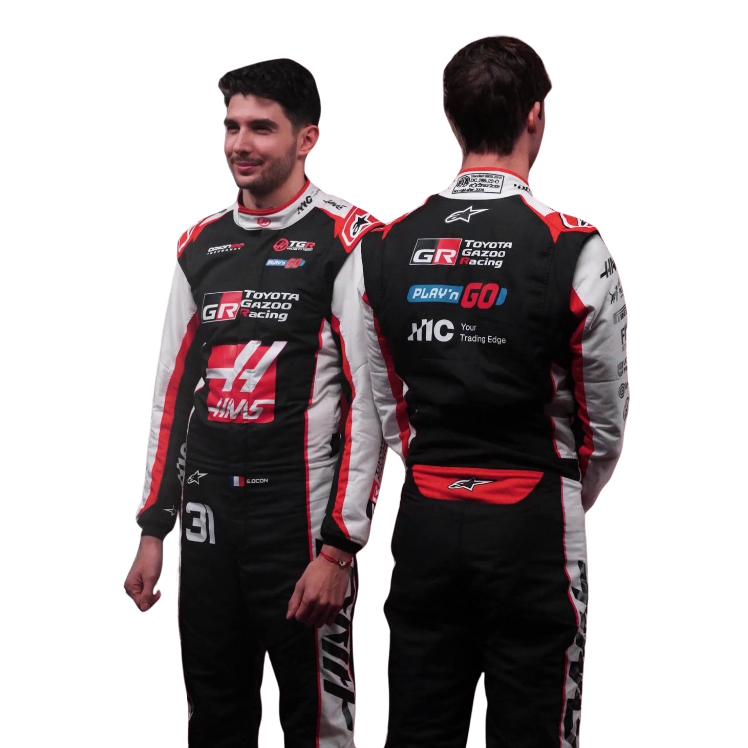 Esteban Ocon, wearing a Toyota Gazoo F1 Haas 2026 Racing racing suit with visible branding, standing with Oliver Bearman- Kartx Gear