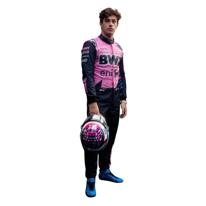 Franco Colapinto wearing a pink and black 2026 Alpine F1 racing suit, holding a helmet on a white background - Kartx Gear
