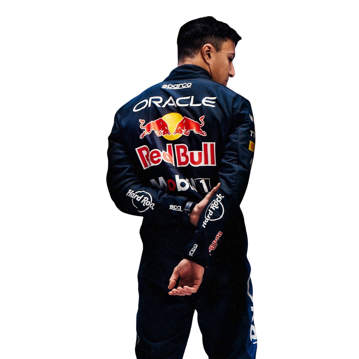 Isack Hadjar wearing a dark blue 2026 Red Bull F1 racing suit with Red Bull and Oracle logos - Kartx Gear