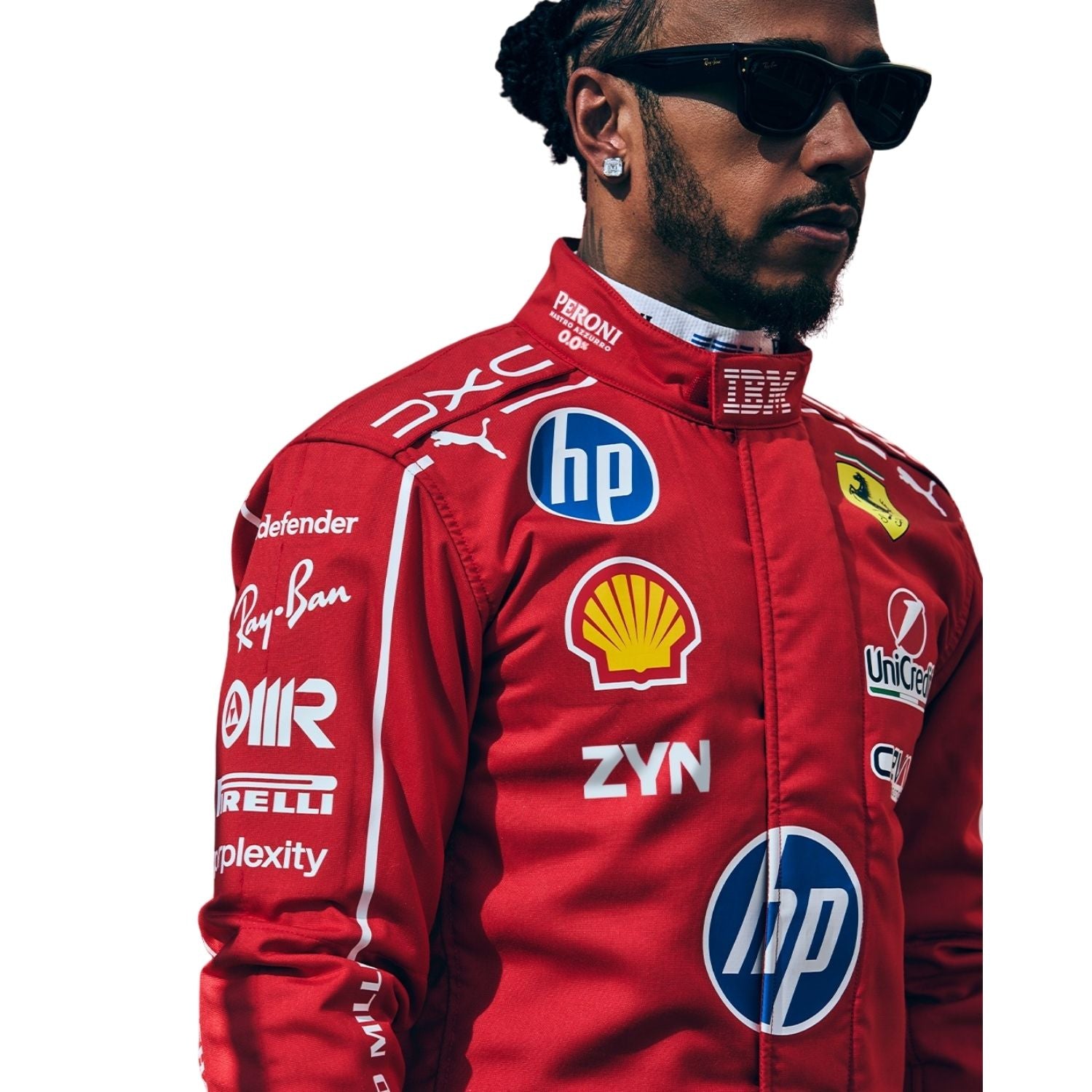 A Lewis Hamilton wearing a red Ferrari racing suit with multiple sponsor logos, black sunglasses, and a beard, shown against a plain white background.