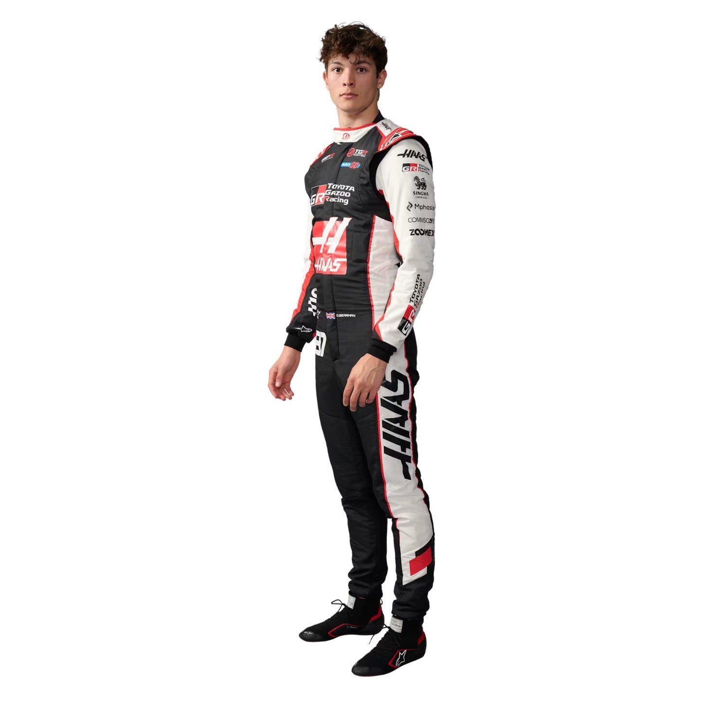 Oliver Bearman wearing a black and white 2026 F1 HAAS racing suit with various sponsor logos on a white background - Kartx Gear