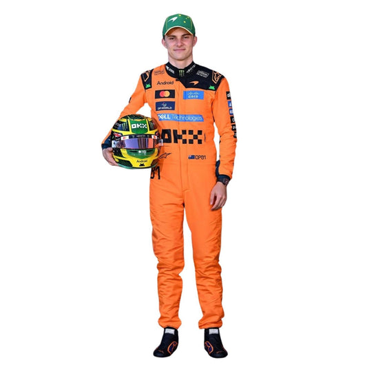 Oscar Piastri wearing an orange McLaren 2026 F1 racing suit, holding a helmet - Kartx Gear