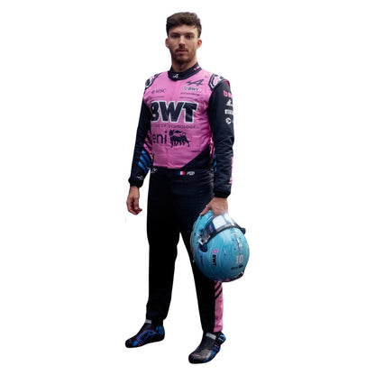 Pierre Gasly wearing a 2026 Alpine f1 racing suit with visible branding, holding a helmet on a white background - Kartx Gear