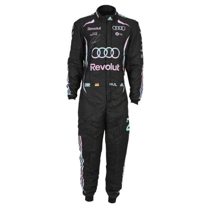 A black racing one-piece suit with pink and light blue accents, featuring prominent Audi and Revolut sponsor logos, Adidas branding, and signatures on the chest, displayed against a solid white background.