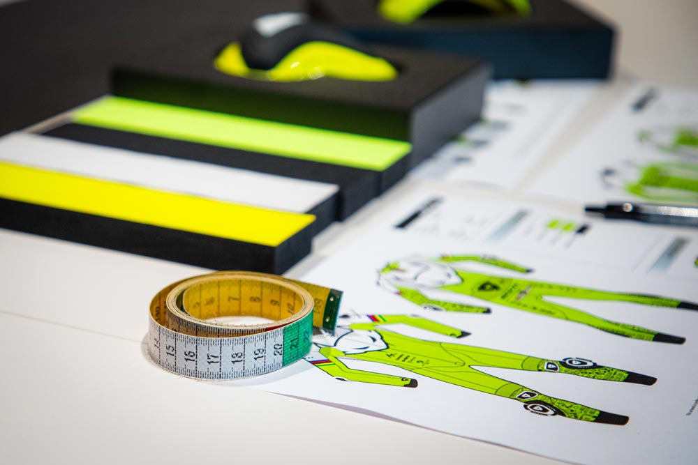 Measurement tools and clothing design prints on a table - Kartx Gear